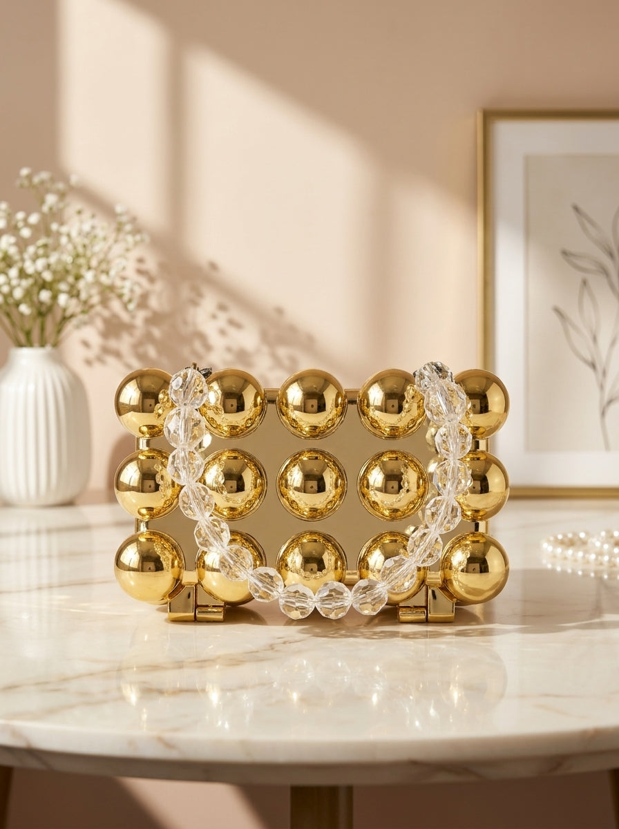 Gold bubble-studded spherical evening clutch with chain strap